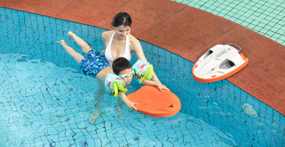 Child enjoying swimming with SUBLUE Swii kickboard alongside adult instructor.